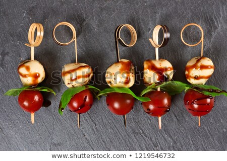 Stock photo: Skewer Tomatoes On A Slate With Salad