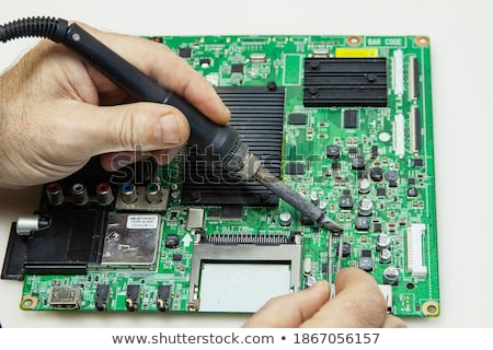 [[stock_photo]]: Television Motherboard With Soldering Iron