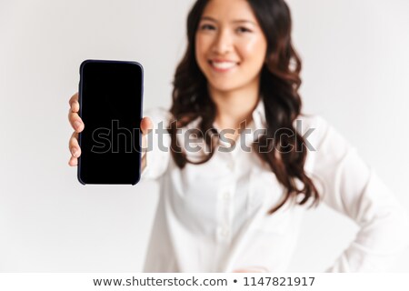 Сток-фото: Blurry Photo Of Smiling Asian Woman With Long Dark Hair Standing