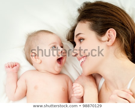 Stock fotó: A Happy Mother With Baby On Bed