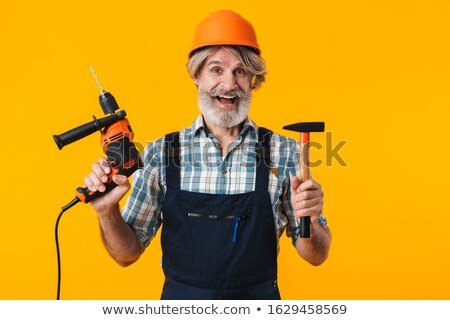 Stockfoto: Positive Elderly Grey Haired Bearded Man Holding Drill