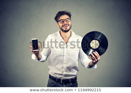 Stockfoto: Happy Hipster Beard Man Holding Vinyl Record Disk And Modern Smartphone