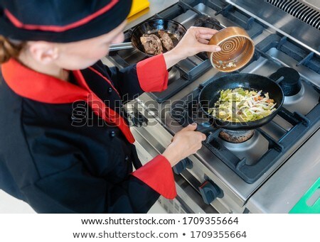 Female Chef And Cabbage In A Wok Foto d'archivio © Kzenon