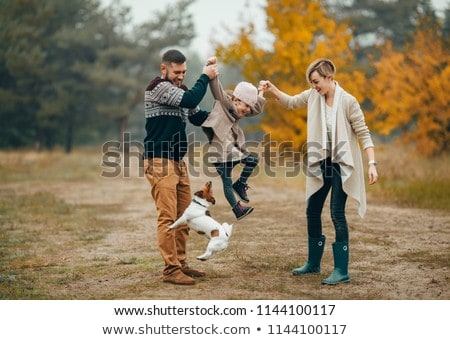 Family Playing With Their Dog In The Park Stok fotoğraf © Stasia04