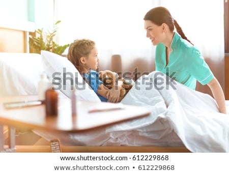 Stockfoto: Little Girl In Hospital Bed With The Nurse