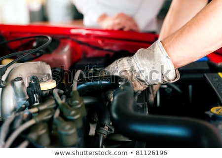 Car Mechanic In His Repair Shop Standing Next To The Car Stockfoto © Kzenon
