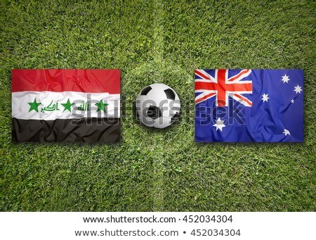 Stok fotoğraf: Australia Vs Iraq Flags On Soccer Field