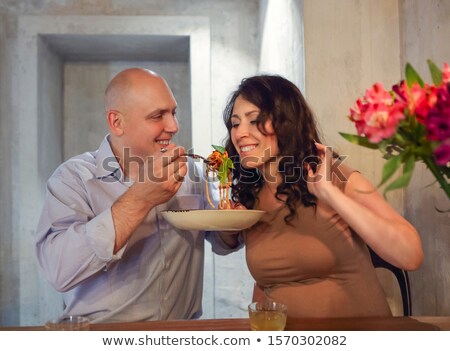 Foto stock: Man And Woman Eating Bolognese Spaghetti In Restorant