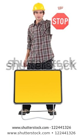 Stock photo: Carpenter Holds Stop Sign