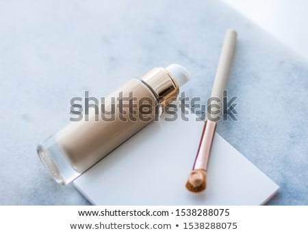 Foto stock: Makeup Foundation Bottle And Contouring Brush On Marble Make Up
