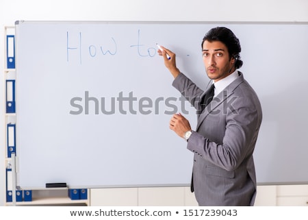 Stock photo: Young Handsome Businessman In Front Of Whiteboard