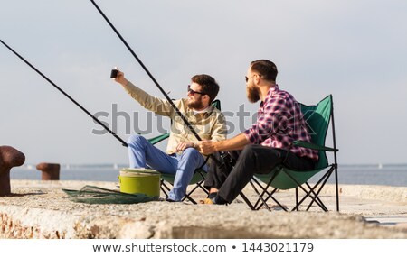 Stockfoto: Friends Fishing And Taking Selfie By Smartphone