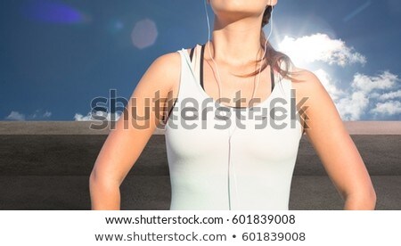 Zdjęcia stock: Fitness Woman Torso Listening Music Against Sky Background