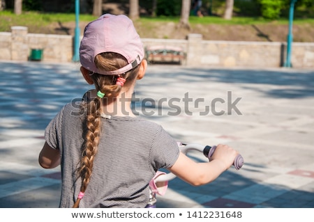 [[stock_photo]]: Six Year Old Boy Biking In The Park