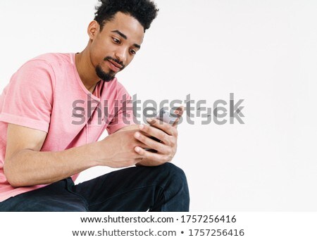 [[stock_photo]]: Image Of Optimistic African American Man Sitting Over Wall At Ho