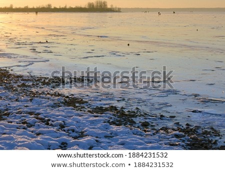 Foto stock: Cold Sunset With Silhouette Of Beach Dunes