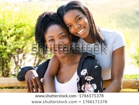 Mother And Teen Daughter Sitting On Bench On Street ストックフォト © Lopolo