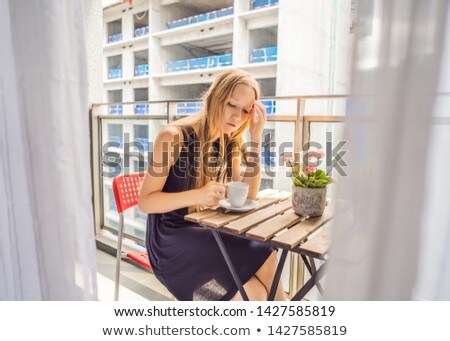 Stock photo: Young Woman On The Balcony Annoyed By The Building Works Outside Noise Concept Air Pollution From