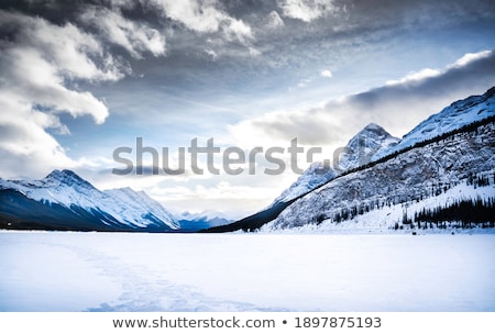 ストックフォト: Snow Covers Mountains Peaks Under Dramatic Sky
