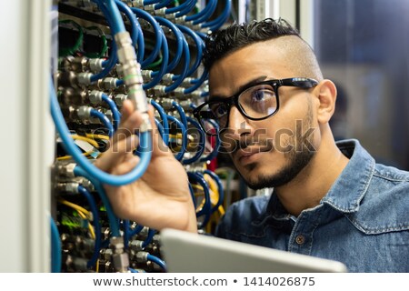 [[stock_photo]]: Technical Engineer Examining Mainframe Computer