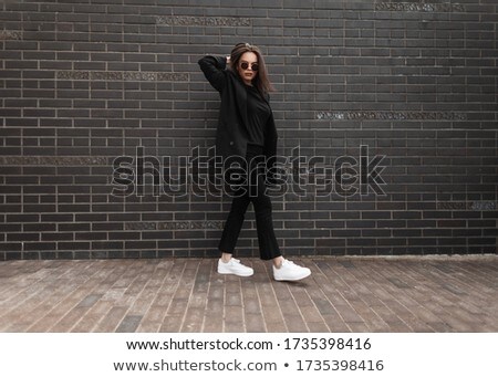 Beautiful Girl Walks In The City Near The Black Wall In The Rain Stok fotoğraf © Alones