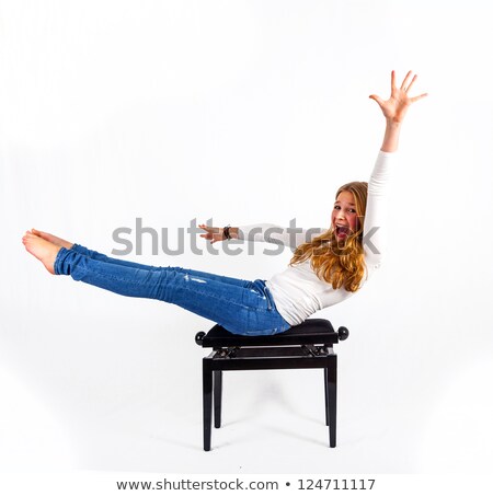 ストックフォト: Woman Demonstrates Fitness Exercises On A Piano Chair