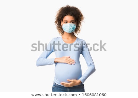 Stock photo: Pregnant Womans Abdomen Against Black Background