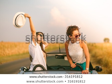 Stok fotoğraf: Two Young Girls Having Fun In The Cabriolet Outdoors