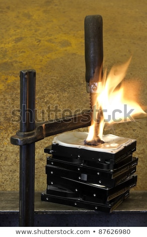 Stock photo: Pressed Hard Drives With Clamp And Fire