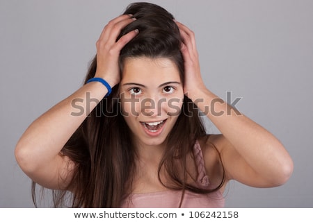 Stok fotoğraf: Surprised Pretty Woman With Ands At Her Head