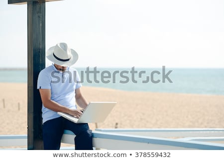 [[stock_photo]]: Excited Businessman Sitting On A Bench In Park With Laptop