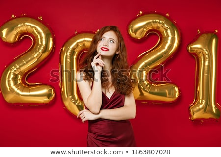 Stockfoto: Festive Redhead With Hand On Chin