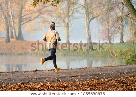 Сток-фото: Unrecognizable Hooded Man Jogging Outdoors