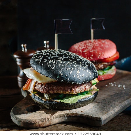 Stock fotó: Black Burger A Burger With A Black Roll Slices Of Juicy Marble Beef Fused Cheese Fresh Salad And