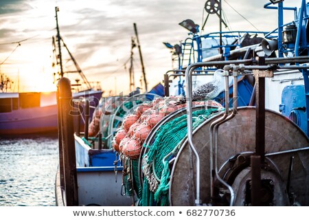 Stok fotoğraf: Fishing Boat Moored In A Storm At Sunrise