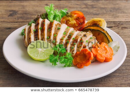 ストックフォト: Grilled Chicken Breast Served On Plate With Parsley And Lemon Wooden Background