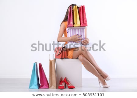 Foto d'archivio: Beautiful Young Woman With Shopping Bags And Boxes Isolated On Pink