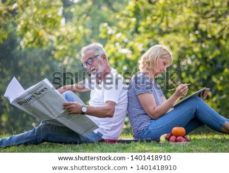 Stock foto: Happy Senior Woman Reading Diary At Autumn Park