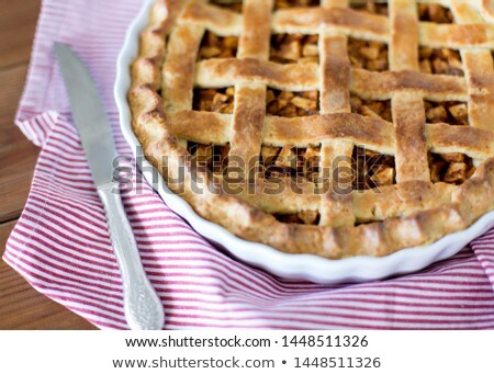 Foto stock: Close Up Of Apple Pie In Baking Mold On Towel
