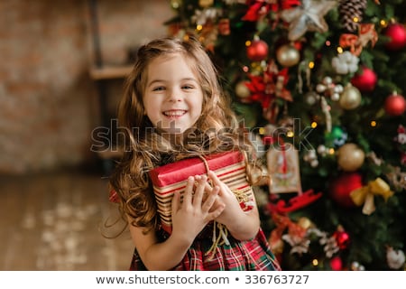 Stock photo: Young Smiling Girl With Red Hat And Present Christmas