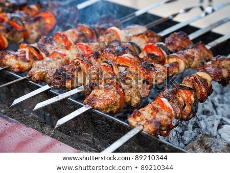 Stock photo: Shish Kebab Slices Of Meat With Sauce Preparing On Fire