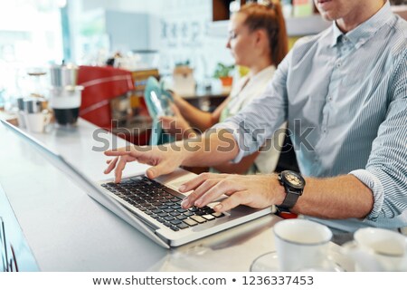 [[stock_photo]]: Crop Cafeteria Owner Using Laptop At Counter