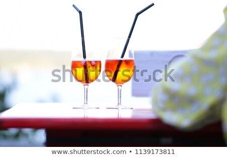 Foto stock: Two Glasses Of Bellini Cocktail With Bouquet Of Roses