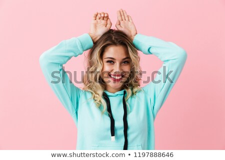Foto stock: Photo Of Amusing Woman In Basic Clothing Smiling And Showing Rab