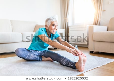 Senior Woman Stretching Her Body Yoga At Home Zdjęcia stock © Photoroyalty