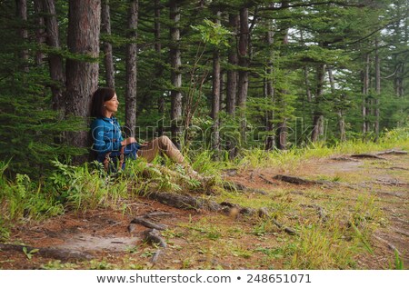 Foto d'archivio: Female Hiker With Backpack Sitting On Forest Path
