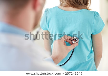 [[stock_photo]]: A Male Doctor Listens To A Girls Back