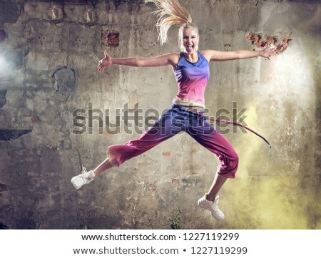 Stock foto: Pretty Blond Woman Dancing In A Grungy Place
