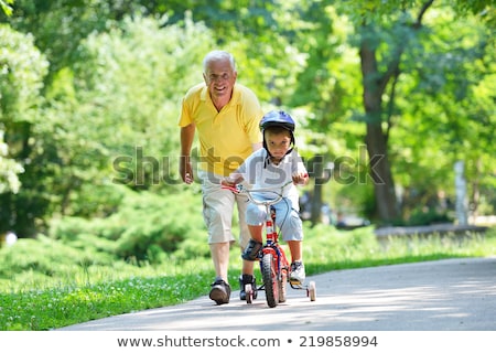 Stock photo: Grandfather And Boy With Bicycle At Summer Park