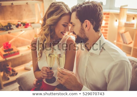 Stock photo: Portrait Of Beautiful Young Woman With Man Holding Champagne Flu